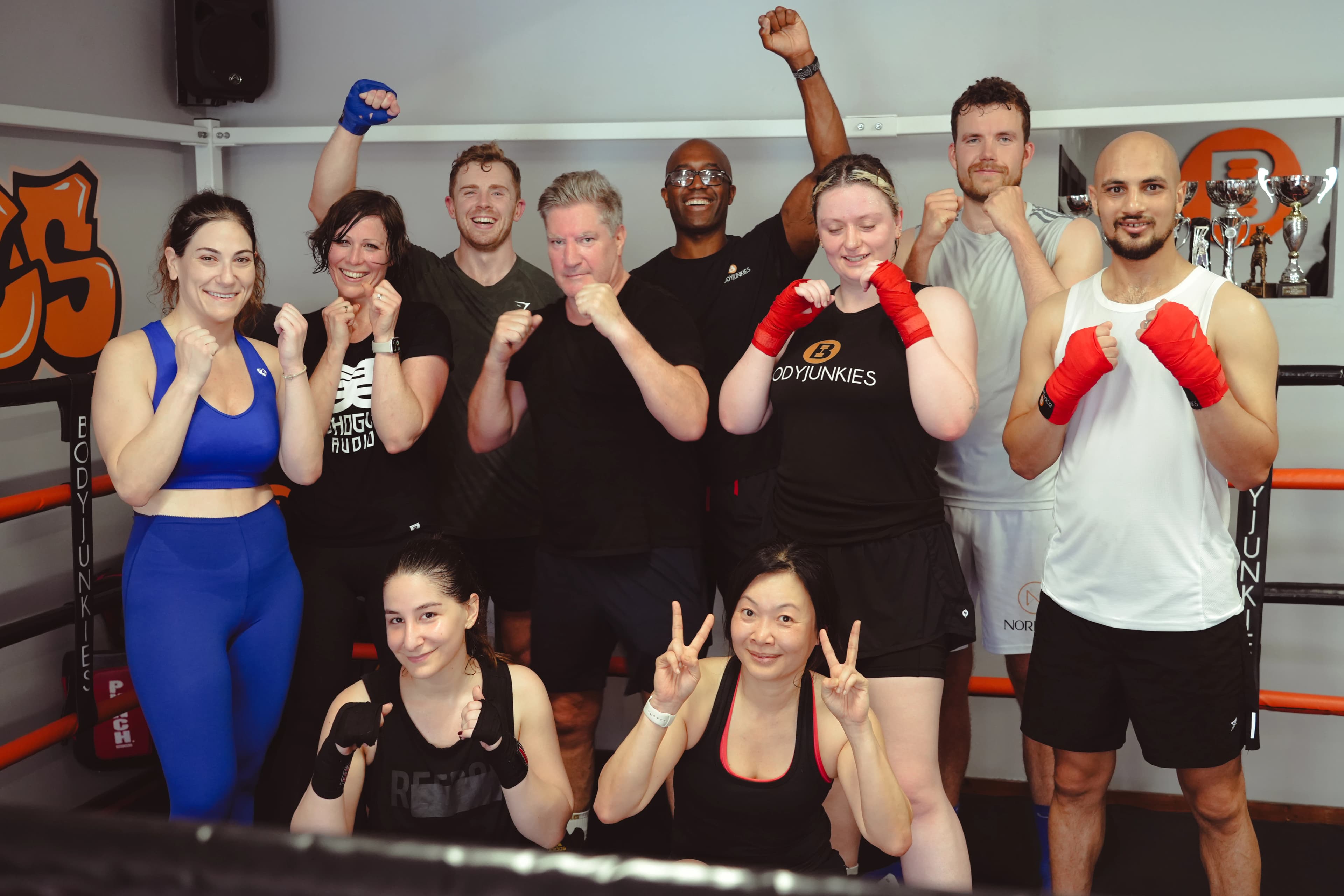Bodyjunkies members training together with wraps on, smiling and standing proud after class